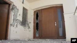 The front door of Mohammed Gadhafi's Tripoli house damaged during his brief capture.