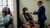 A woman is vaccinated against COVID-19 at the Hillbrow Clinic in Johannesburg, South Africa, Dec. 6, 2021.