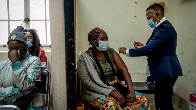 A woman is vaccinated against COVID-19 at the Hillbrow Clinic in Johannesburg, South Africa, Dec. 6, 2021.