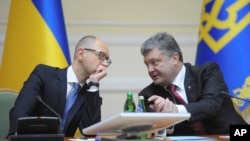 Presiden Ukraina Petro Poroshenko (kanan) berbincang dengan PM Arseniy Yatsenyuk di Kyiv, Ukraina (10/9).