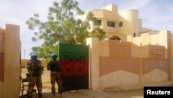 FILE - MINUSMA peacekeepers stand guard in front of the governor's office in Kidal, Mali.