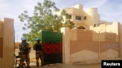 FILE - MINUSMA peacekeepers stand guard in front of the governor's office in Kidal, Mali.