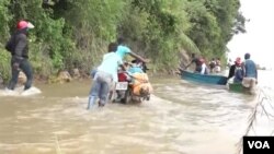 Des Congolais empruntant la route d'Uvira Baraka dans la province du Sud-Kivu emprutent les eaux du lac Tanganyika avec des pirogues pour traverser l'eau à Lwanga.