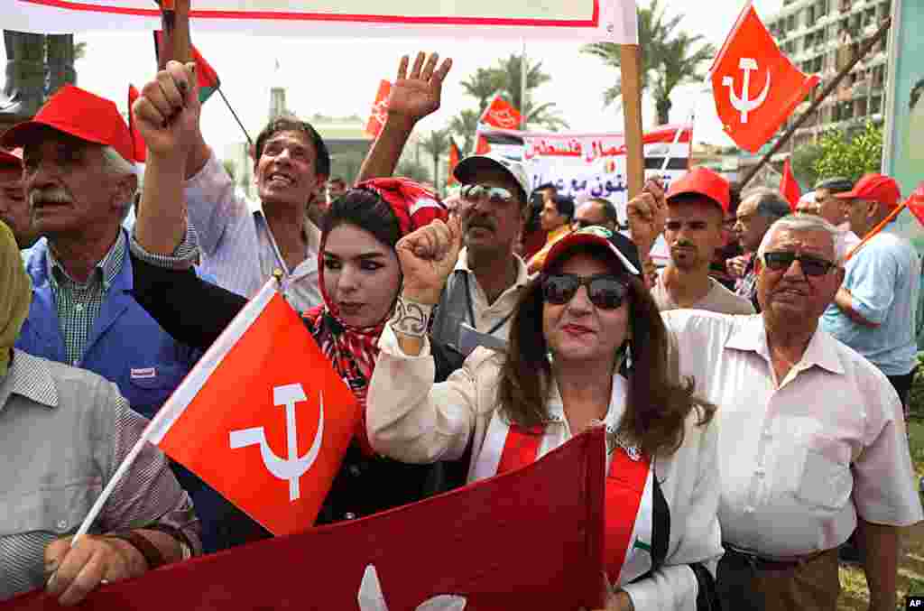 Supporters of the Iraqi Communist Party wave communist and national flags during a May Day celebration in Baghdad, Iraq, May 1, 2017.