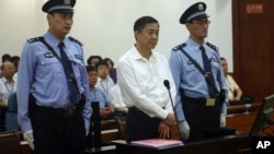 The Chinese court said it will deliver a verdict on Sept. 22 for Bo Xilai, center, on charges of bribery, embezzlement and abuse of power in a case set in motion by his wife's murder of a British businessman, (File photo).. 