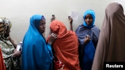 FILE - Suspected Somali illegal migrant Leyla Ali Adow (C) reacts after being processed for deportation in Nairobi.