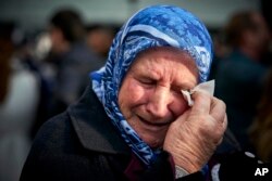 Nura Mustafic, one of the Mothers of Srebrenica and other Bosnian organizations, wipes away tears as she reacts to the verdict which the Yugoslav War Crimes Tribunal, ICTY, handed down in the genocide trial against former Bosnian Serb military chief Ratko