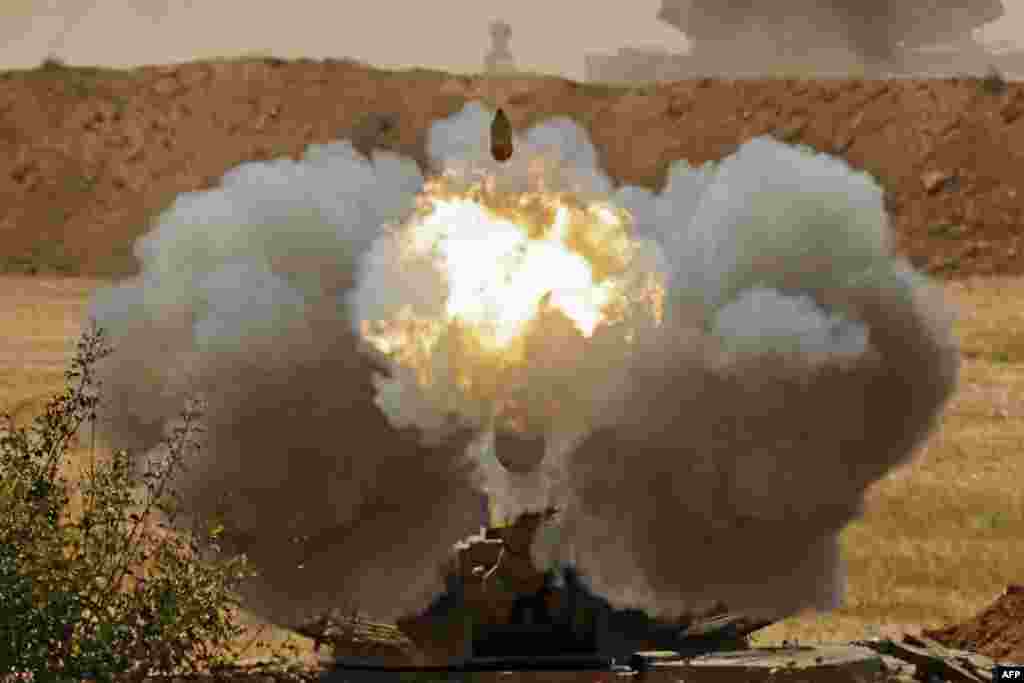 Israeli soldiers fire a 155mm self-propelled howitzer towards the Gaza Strip from their position along the border in the southern Israeli city of Sderot.