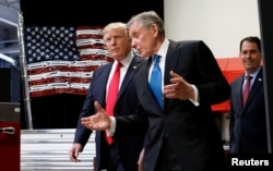 U.S. President Donald Trump tours the headquarters of Snap-On Inc. with CEO Nick Pinchuk as Wisconsin Governor Scott Walker follows, in Kenosha, Wisconsin, April 18, 2017.