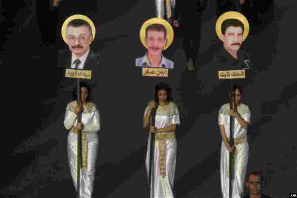 Egyptian Copt girls march in Cairo, as they carry pictures of some of the victims who were killed in clashes with the military last Oct.9, during a mourning march in Egypt, Friday, Nov.11, 2011. (AP Photo/Amr Nabil)