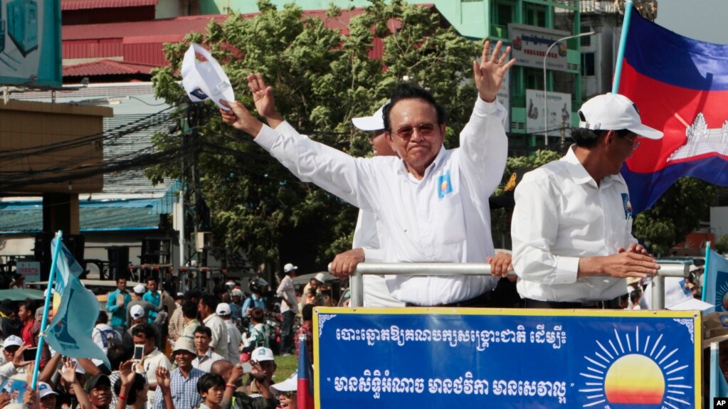 FILE - In this June 2, 2017, file photo, opposition party Cambodia National Rescue Party (CNRP) leader Kem Sokha greets his supporters at a rally in Phnom Penh. The European Union said Tuesday it has suspended assistance to Cambodiaâ€™s election commission following last monthâ€™s dissolution of the countryâ€™s main opposition party and warned that next Julyâ€™s general election will not be legitimate if the opposition is not allowed to participate. (AP Photo/Heng Sinith, File)