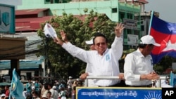 FILE - In this June 2, 2017, file photo, opposition party Cambodia National Rescue Party (CNRP) leader Kem Sokha greets his supporters at a rally in Phnom Penh, Cambodia. 