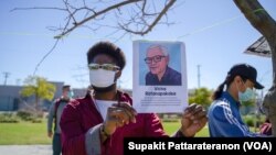 An African-American holding a portrait picture of Vicha Ratanapakdee during the Asian American event to raise awareness about the increase in hate crimes against Asians in the US near Chinatown Los Angeles, CA. 