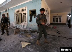 FILE - Afghan security forces inspect the site of a suicide attack in Jalalabad, Afghanistan, Jan. 17, 2016. The Taliban has not yet indicated whether it intends to joint the peace process.