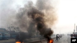 Supporters of Bangladesh's Islamic party Jamaat-e-Islami burn tires to block traffic during a general strike in Dhaka, Bangladesh, Thursday, Jan. 31, 2013. The party called a nationwide shutdown for Thursday to back its demand that the government stop a t