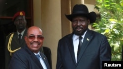 Description: South Sudan's President Salva Kiir (R) welcomes his Sudanese counterpart Omar al Bashir outside his presidential office in Juba on Friday, April 12, 2013. (Reuters)