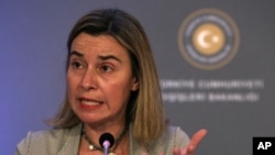 FILE - The European Union's Federica Mogherini, shown speaking to reporters in Ankara last December, will be the highest-ranking EU diplomat to visit Cuba.