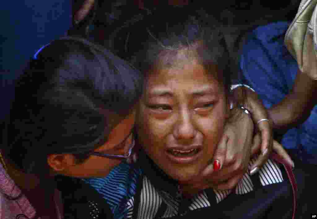 A relative of one of the Nepalese climbers killed in an avalanche on Mount Everest cries during the funeral ceremony in Katmandu, Nepal, April 21, 2014.