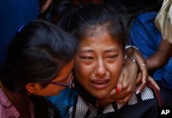 FILE - A relative of one of the Nepalese climbers killed in an avalanche on Mount Everest cries during the funeral ceremony in Katmandu, Nepal, April 21, 2014.