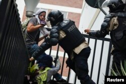 Venezuela's national police detain anti-government protesters during a protest against President Nicolas Maduro's government in Caracas May 8, 2014.