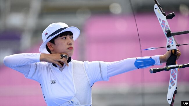 South Korea's An San competes in the women's individual during the Tokyo 2020 Olympic Games at Yumenoshima Park Archery Field in Tokyo on July 30, 2021. (Photo by ADEK BERRY / AFP)