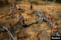 Indigenous people from the Mura tribe show a deforested area in unmarked indigenous lands inside the Amazon rainforest near Humaita, Amazonas State, Brazil August 20, 2019. Picture taken August 20, 2019. REUTERS/Ueslei Marcelino