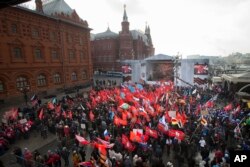 FILE - Activists from Russia’s Anti-Maidan movement rally near the Kremlin in Moscow, Feb. 21, to mark the anniversary of what they call the 'fascist coup' in neighboring Ukraine.