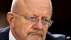 FILE - National Intelligence Director James Clapper testifies on Capitol Hill, April 18, 2013, before the Senate Armed Services Committee hearing on the current and future threats to national security. 