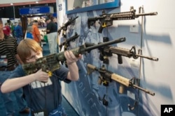 FILE – Assault-style rifles are on display during the National Rifle Association's annual convention in Houston, Texas, May 3, 2013.