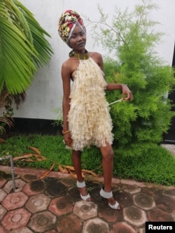 A model poses in a dress made of condoms by Felicite Luwungu in Kinshasa, Democratic Republic of Congo, Dec. 5, 2017.