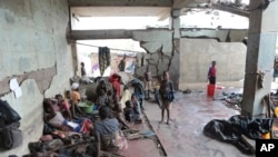 Survivors of Cyclone Idai wait in an abandoned and derelict building near Nhamatanda, about 50 kilometers from Beira, in Mozambique, March, 22, 2019. 