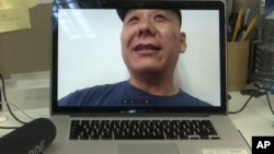 Chinese dissident Zhang Xiangzhong is seen on a computer screen during an interview via videoconference April 17, 2017, in Taipei, Taiwan.