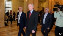 FILE - Former deputy Northern Ireland First Minister Martin McGuinness, center, at Stormont, Belfast, Northern Ireland, Jan. 16, 2017. McGuinness died Tuesday at age 66.