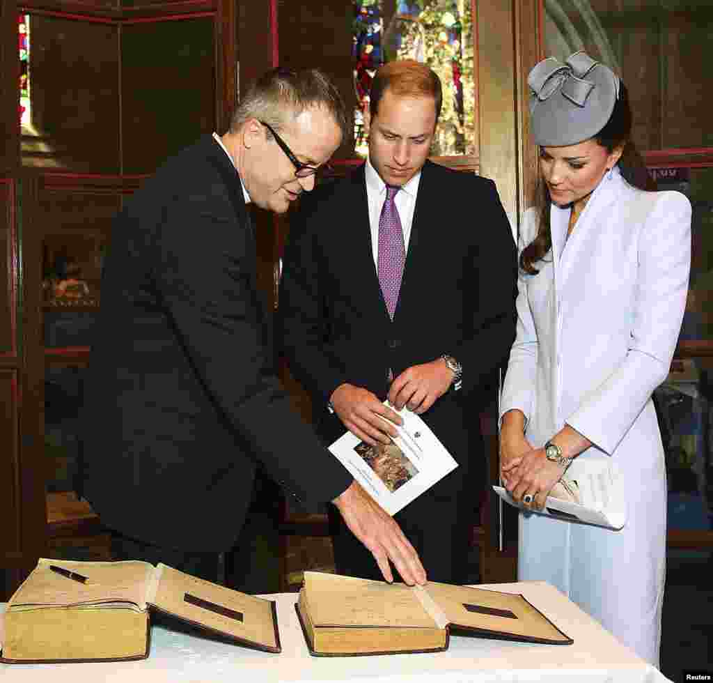 Britain&#39;s Prince William and his wife Catherine, Duchess of Cambridge prepare to sign the First Fleet Bible and Prayer Book following Easter Sunday Service at St. Andrews Cathedral in Sydney, April 20, 2014.&nbsp;