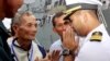 In this photo taken Dec. 3, 2010, U.S. navy officer Michael "Vannak Khem" Misiewicz, right, greets his relatives at Cambodian coastal international see port of Sihanoukville, about 220 kilometers (137 miles) southwest of Phnom Penh, Cambodia. Misiewicz finally returned home Friday as commander of the U.S. Navy destroyer USS Mustin, reuniting with the relatives who wondered whether they would ever see him alive, and the aunt who helped arrange his adoption. His ship departs Monday. (AP Photo/Heng Sinith)