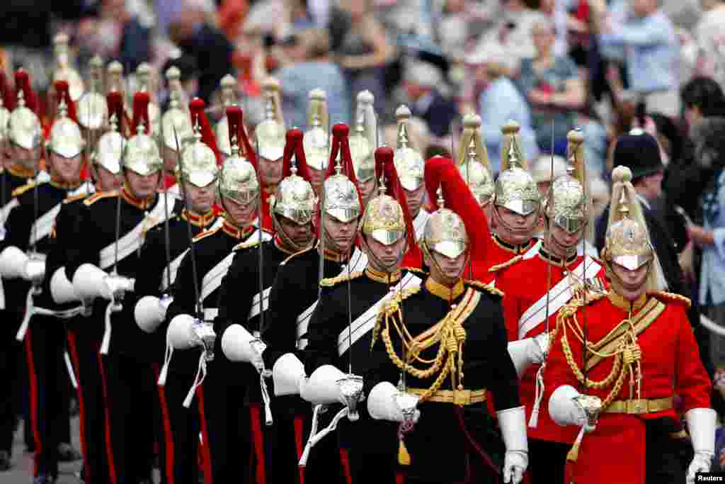 Household Cavalry guards march before the Order of the Garter Service at Windsor Castle, Windsor, Britain.