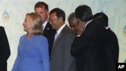 U.S. Secretary of State Hillary Rodham Clinton, in blue, walks with Chinese Foreign Minister Yang Jiechi, center, and other ministers after a group photo prior to the start of ASEAN Regional Forum Retreat Session in Nusa Dua, Bali, Indonesia, Saturday, Ju