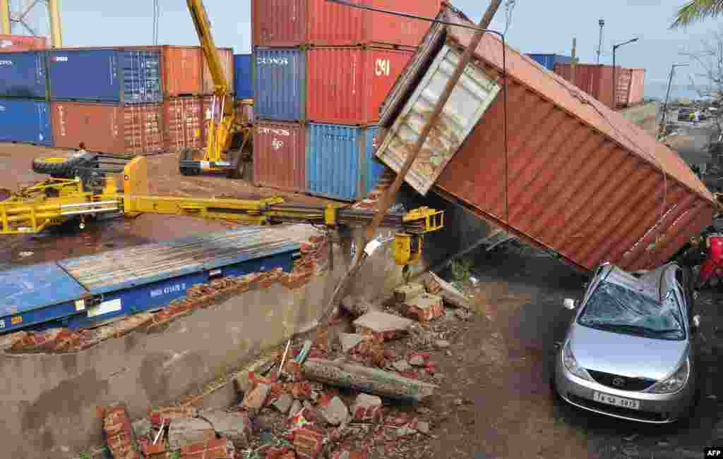 A shipping container fell from the walls in a harbor in Chennai, India, Dec. 12, 2016. At least 10 people were killed when Cyclone Vardah slammed into the southern Indian tech hub of Chennai, bringing down houses and cutting off the electricity supply, authorities said.