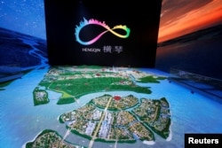 A layout of Hengqin Island under development is displayed inside a government showroom on Hengqin Island, adjacent to Macau, China, Sept. 13, 2017.