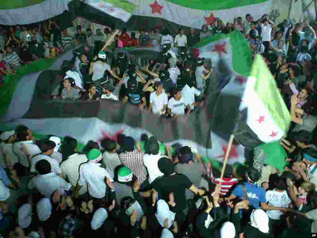 This citizen journalism image provided by Kfar Suseh Coordinating of the Syrian Revolution shows anti-Syrian regime protesters in Damascus, June 7, 2012.