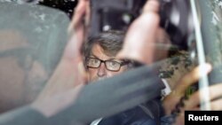 Chief Executive of G4S Nick Buckles is seen through a tinted car window as he leaves the Houses of Parliament in London, England, July 17, 2012.