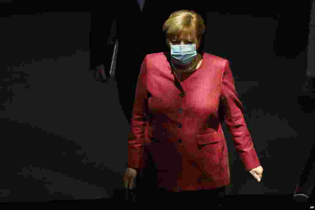 German Chancellor Angela Merkel arrives for a debate about her policy as part of Germany&#39;s budget 2021 debate at the parliament Bundestag in Berlin, Germany, Wednesday, Sept. 30, 2020. (AP Photo/Markus Schreiber)