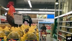 A shopper pushes a cart down a quiet Lotte Mart in Beijing, China, March 17, 2017.