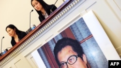 FILE - Zhang Qing, left, wife of Chinese human rights activist Guo Feixiong, and daughter Yang Tianjiao speak at a press conference before a hearing of a House Foreign Affairs Committee subcommittee in Washington, D.C., October 29, 2013.