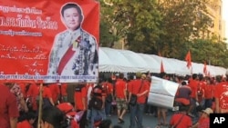 One red-shirted protester in Thailand holds a picture of former Prime Minister Thaksin Shinawatra, who was ousted in a coup in 2006