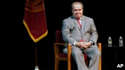 FILE - In this Oct. 20, 2015, photo, US Supreme Court Justice Antonin Scalia waits during an introduction before speaking at the University of Minnesota.