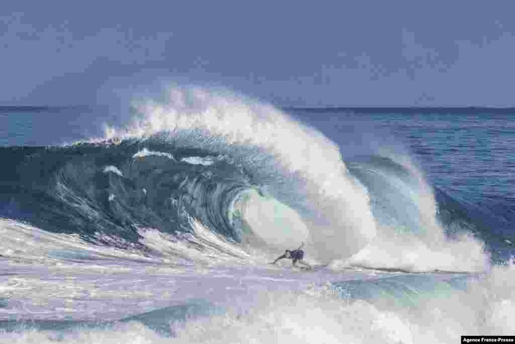 A surfer turns as the wave flairs out during practice ahead of the 2022 Billabong Pipeline Masters, on the north shore of Oahu, Hawaii, Jan. 19, 2022.