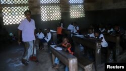 A teacher leads a class at the Wangata commune school during a vaccination campaign against the outbreak of Ebola, in Mbandaka, Democratic Republic of the Congo, May 23, 2018.