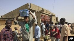 Witnesses at the house in Kano, Nigeria, security forces surrounded the house, forcing their way inside, killing a man and a pregnant woman while searching for members of a radical Islamist sect known as Boko Haram, January 24, 2012.