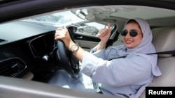 Zuhoor Assiri drives her car in Dhahran, Saudi Arabia, June 24, 2018. 